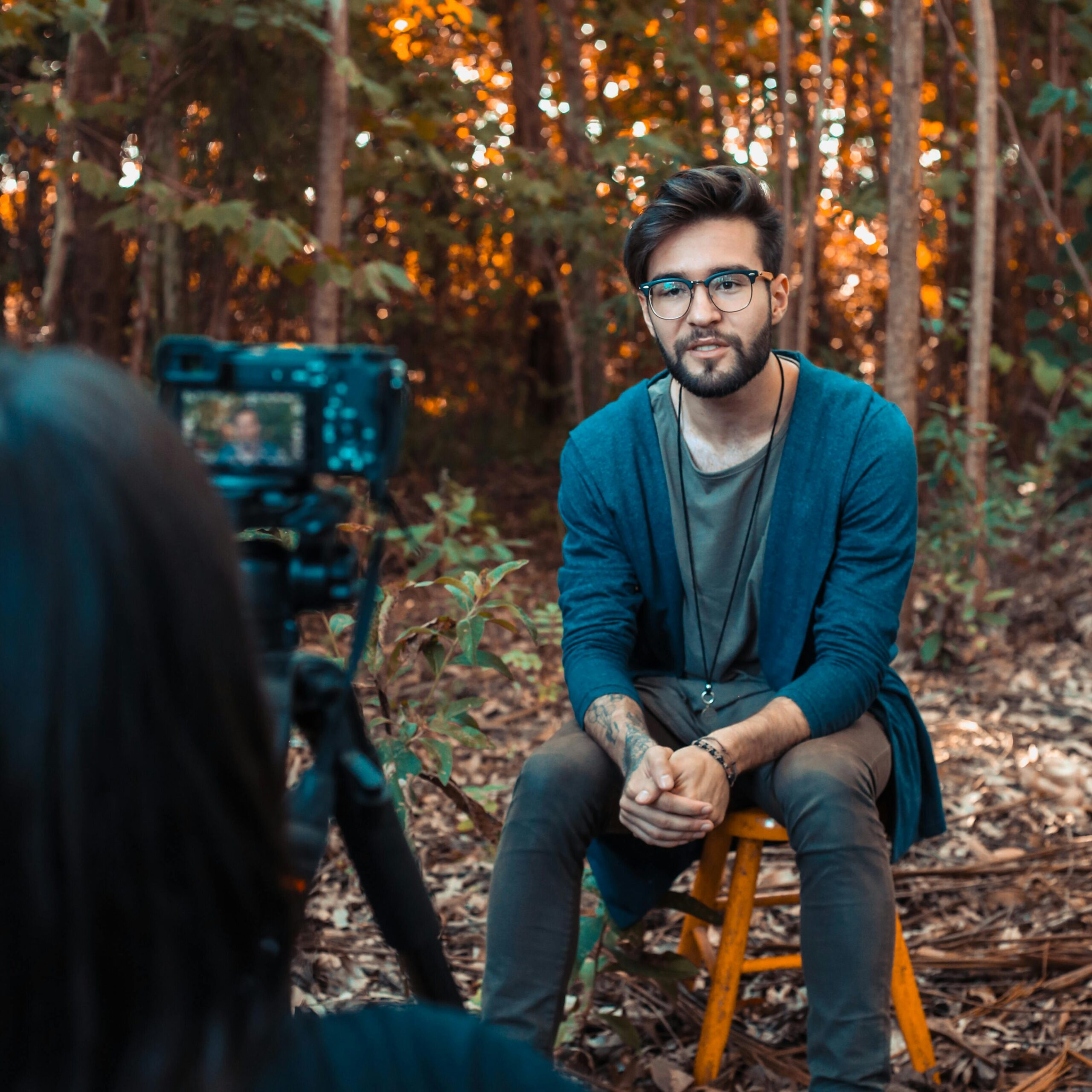 Photo of a Man Sitting in Front of a Camera